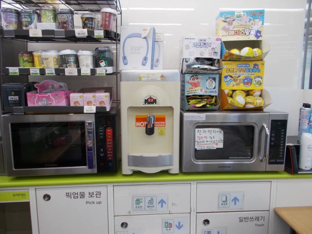 Hot-water dispenser, microwaves and waste bins in a Korean CU convenience store.