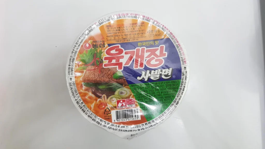 An unopened Nongshim Yukgaejang cup with cooking instructions on the lid.
