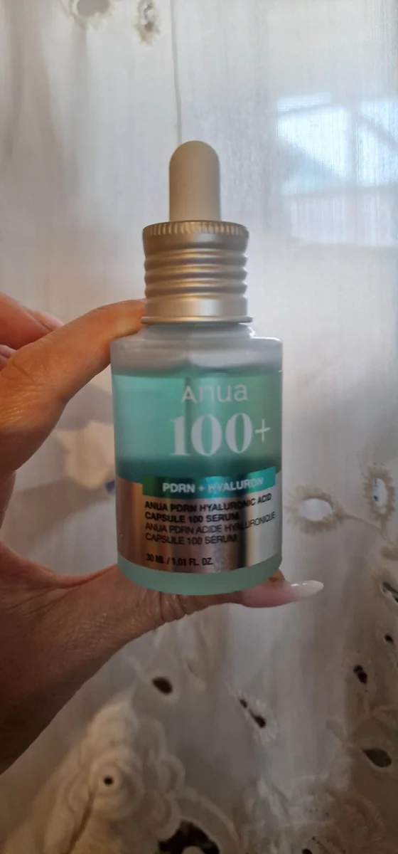 Shopper holding the regular 30ml Anua PDRN Capsule 100 Serum bottle
