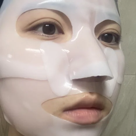 Original Biodance hydrogel mask worn on the face, showing the eye, nose and mouth openings
