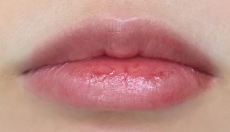 Lips wearing older Peripera Ink Mood Glowy Tint 024, pinkish and glossy under elevator lighting