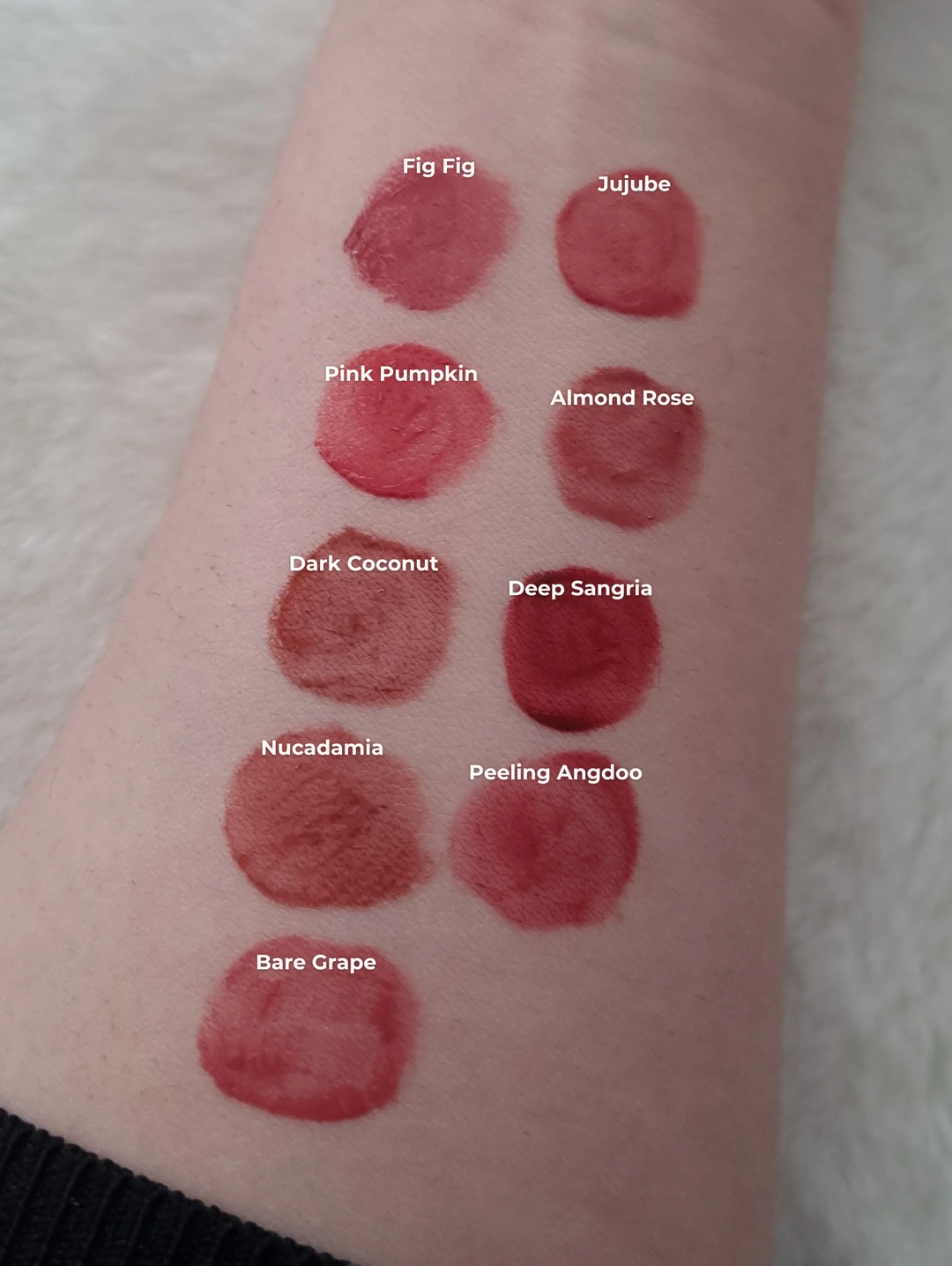 Simply Saima's labeled arm swatches of original rom&nd Juicy Lasting Tint shades in cooler shaded daylight