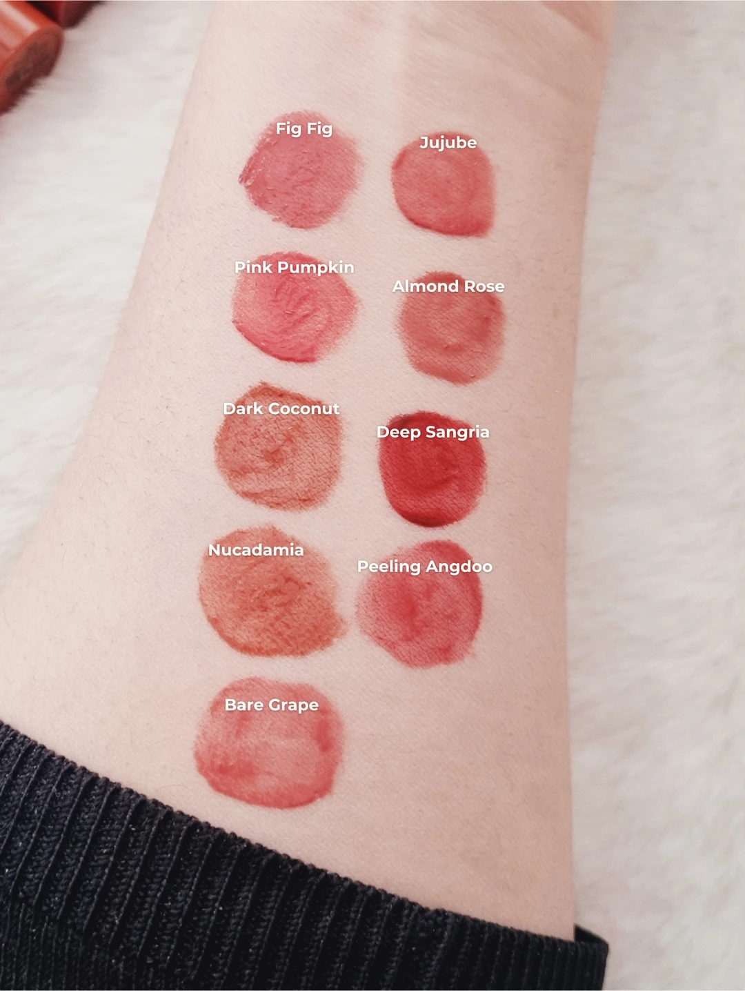 Simply Saima's labeled arm swatches of original rom&nd Juicy Lasting Tint shades in warm bright daylight