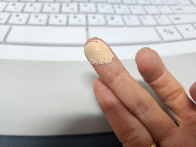 TIRTIR Red Cushion 21N foundation on a fingertip